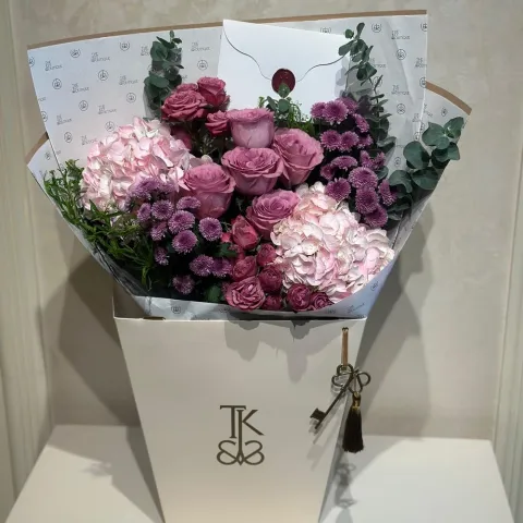 Whispering Secrets Bloom bouquet with pink hydrangeas lavender roses purple chrysanthemums