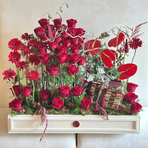 Crimson Embrace luxury bouquet with red roses, gerbera daisies, anthuriums in designer tray