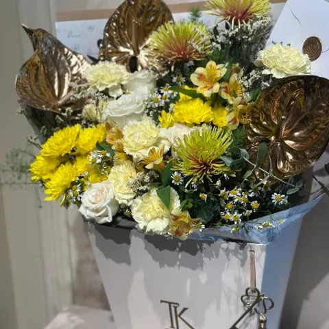Gilded Grace bouquet with white roses and golden anthuriums