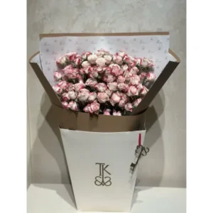 Sprinkles of Joy mini fresh flower bouquet featuring pink and white baby roses and delicate filler flowers, wrapped in elegant paper.