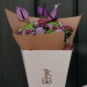 Supreme Velvet Harmony Bouquet: A large, luxurious arrangement of deep red and rich-hued roses and premium filler flowers, designed for a grand romantic gesture.